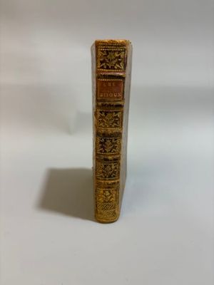 a book that is sitting on a white surface