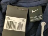 the back of a blue shirt with a barcode on it