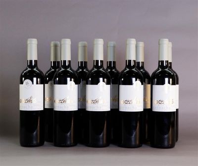 six bottles of wine are lined up in a row on a table