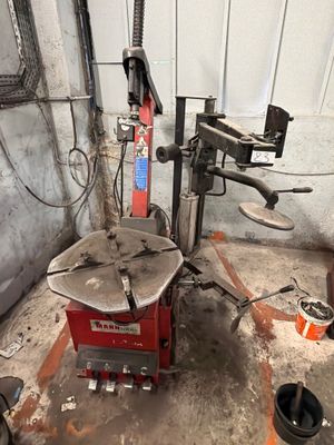a machine that is sitting in a garage with tools