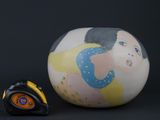 a small vase and a tape measure on a black background