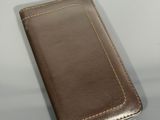 leather case for a cell phone sitting on a table