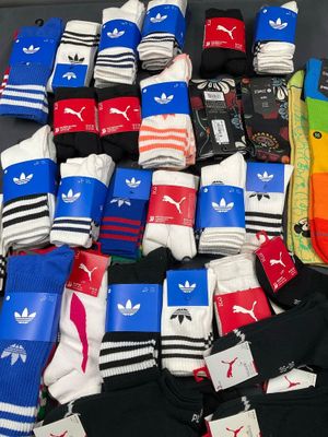 many pairs of socks that are sitting on a table