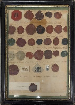 framed photograph of a collection of coins and other items on a wall