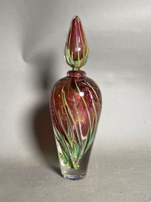 a glass vase with a red and green design on it