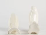 pair of white ceramic rabbit figurines on a white background