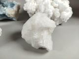 a white rock and some crystals on a white plate