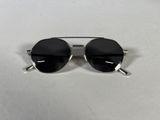 sunglasses on a white table with a white background