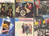several different album covers of various people in a room