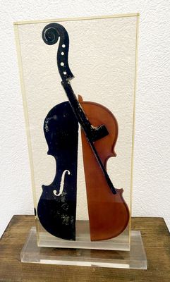 a glass sculpture of a violin and a cello