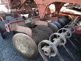 an image of a tractor that is parked on the gravel