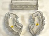 two ashtrays and a cigarette holder on a table