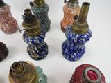 many different colored vases on a white surface