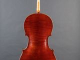 the back of a violin on a stand against a gray background
