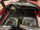 a red car with black leather seats and a steering wheel