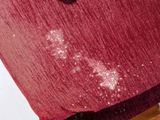 a close up of a red cloth on a chair