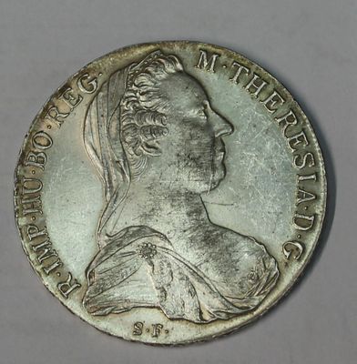 an old silver coin with a woman ' s head on it