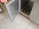 a person that is opening an oven door in the kitchen