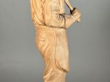 statue of a man with a pipe in his hand and a hat on his head