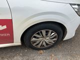 a white car with a red sticker on the side of it