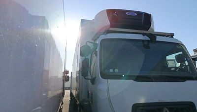 a white truck that is parked next to a wall