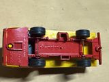 a red and yellow toy truck on a table