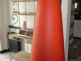 a large vase with a plant in it on a tiled floor