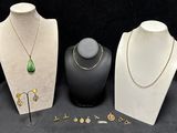 three pieces of jewelry are displayed on display on a black surface