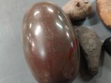 rocks and stones on a table with a wooden spoon