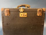 an old suitcase sitting on a table with a blue background