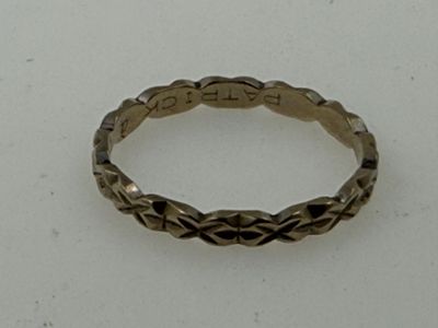 an image of a silver ring on a white surface