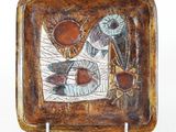 brown and blue ceramic plate with a design of fish on it