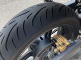 a motorcycle that is parked on the street with its front tire down
