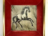 painting of a running horse in a red frame on a white wall