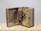 an old camera sitting on a table with its door open