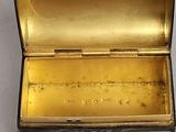 a small box that has a gold and blue design on it