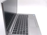 a silver laptop computer sitting on top of a white table