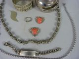 a necklace, bracelet, ring, and other jewelry on a table