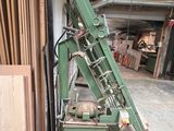 a green machine that is sitting in a garage