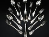 a lot of silver spoons and forks arranged in a circle