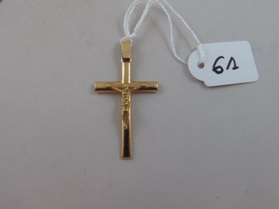 a gold cross on a white string with a price tag on it