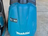 a blue machine that is sitting next to a blue scooter
