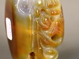 a picture of a yellow and white bead with a dragon on it