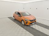 an orange car is parked in a white room with a checkered floor