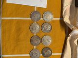 a bag of coins sitting on a table next to a pair of scissors