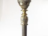 a lamp that has a white glass shade on top of it