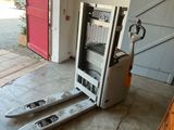 a forklift with skis on it in a garage