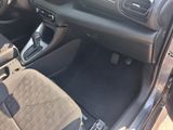 the interior of a car with a steering wheel and dashboard controls
