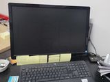 a laptop computer sitting on a desk next to a keyboard