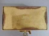 an image of a gold box with a chain hanging from it ' s side